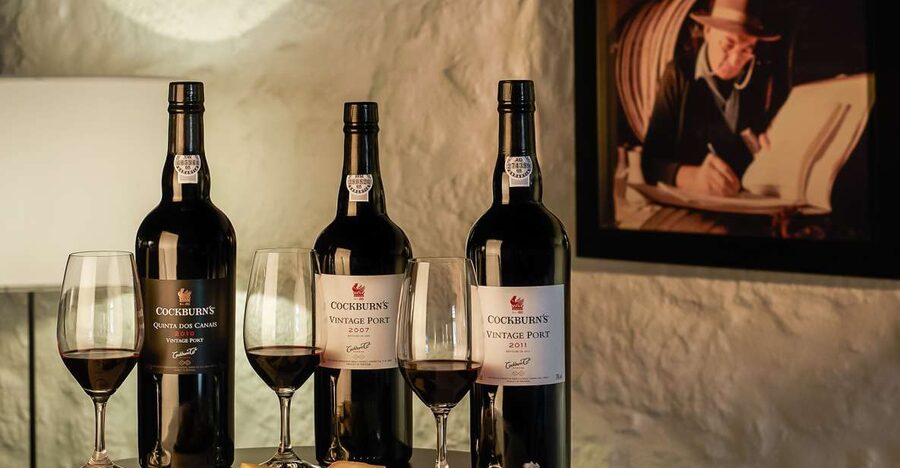 Porto: Cockburn’s Port Lodge Tour and Tasting - Inside the working cellars: museum, granite walls, and the long ageing gallery